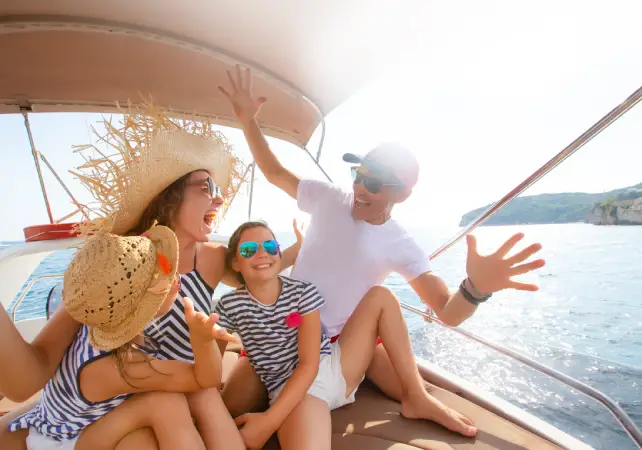 family laughing and having fun on a boat they covered with boat insurance from Vireya