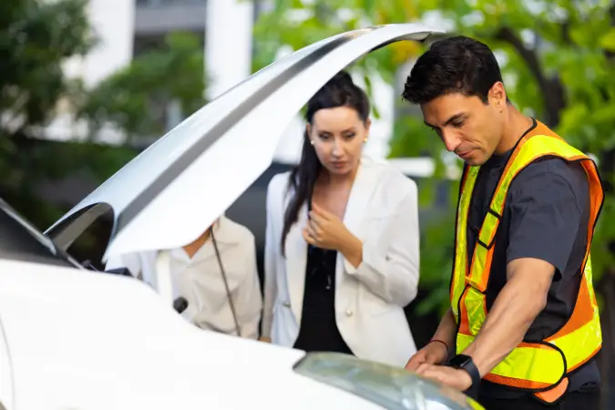 Roadside assistance professional helping a driver with a car breakdown