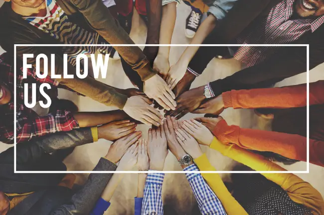 Overhead view of many hands together, with 'FOLLOW US' text