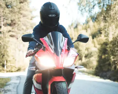 Front view of man riding motorcycle he has protected with motorcycle insurance from Vireya